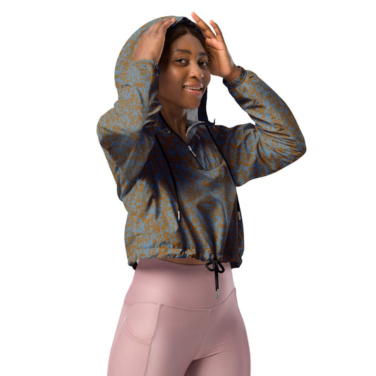 Woman wearing a patterned windbreaker jacket hoodie and pink leggings on a white background