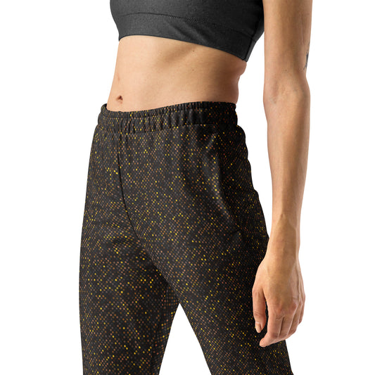Person wearing brown polka dotted patterned slim fit jogger pants on a white background