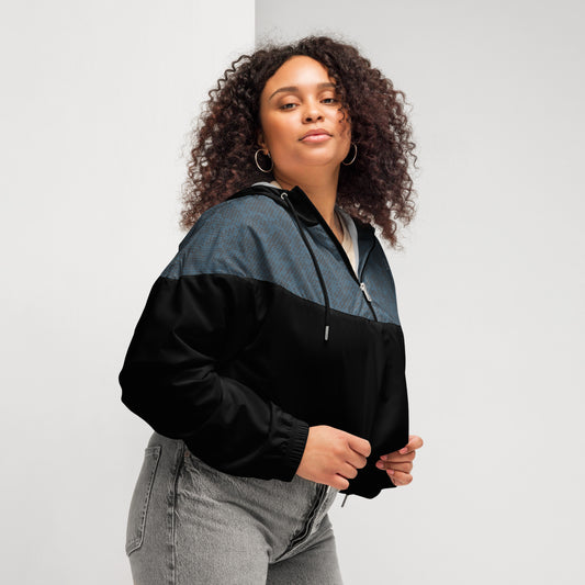 Woman wearing a black and navy jacket against a plain background