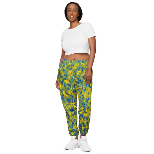 Woman wearing a white crop top and colorful checkered track pants on a white background