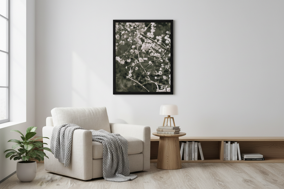 Modern reading nook with a white armchair, framed cherry blossom floral artwork, and a small table