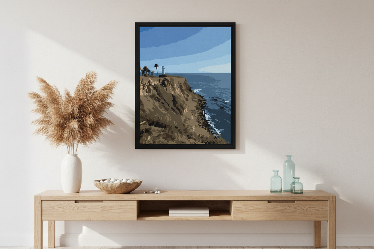 Framed artwork of a coastal ocean scene above a wooden console table with decorative items.