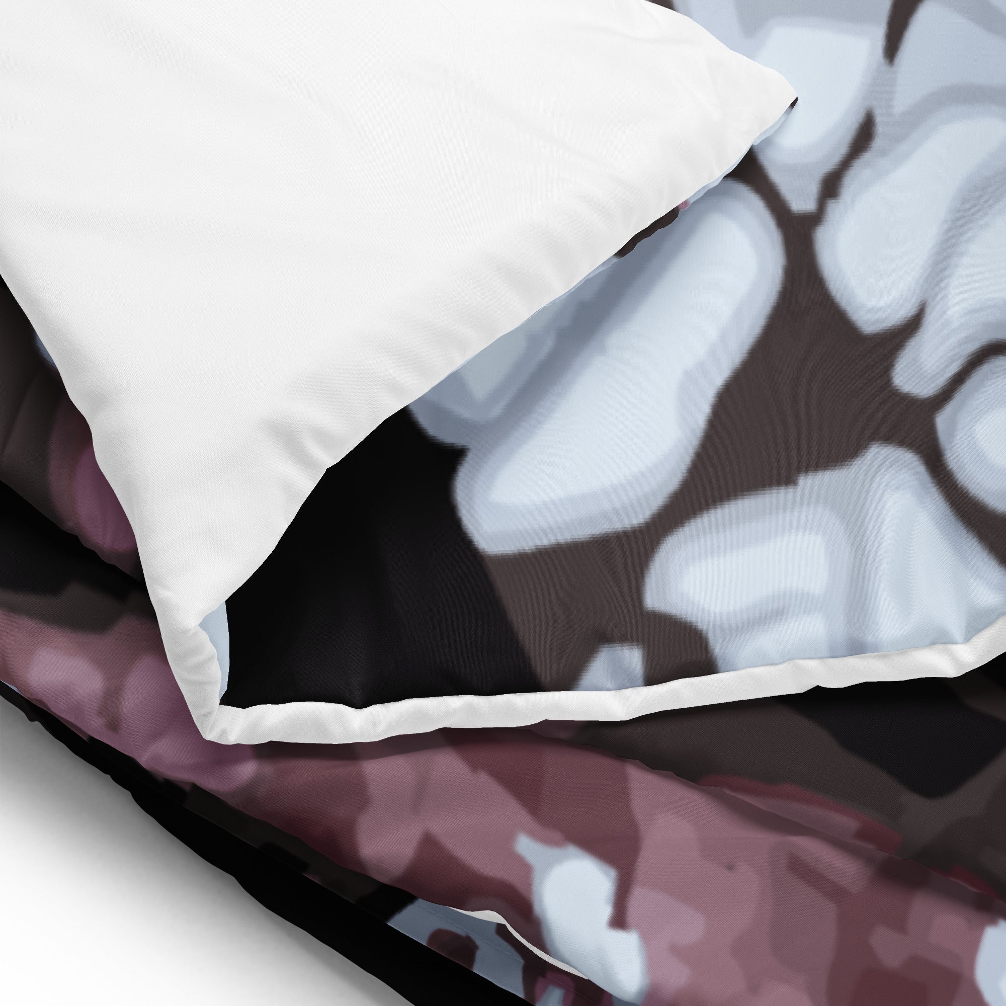 Close-up of a white back of comforter on a dark floral-patterned comforter