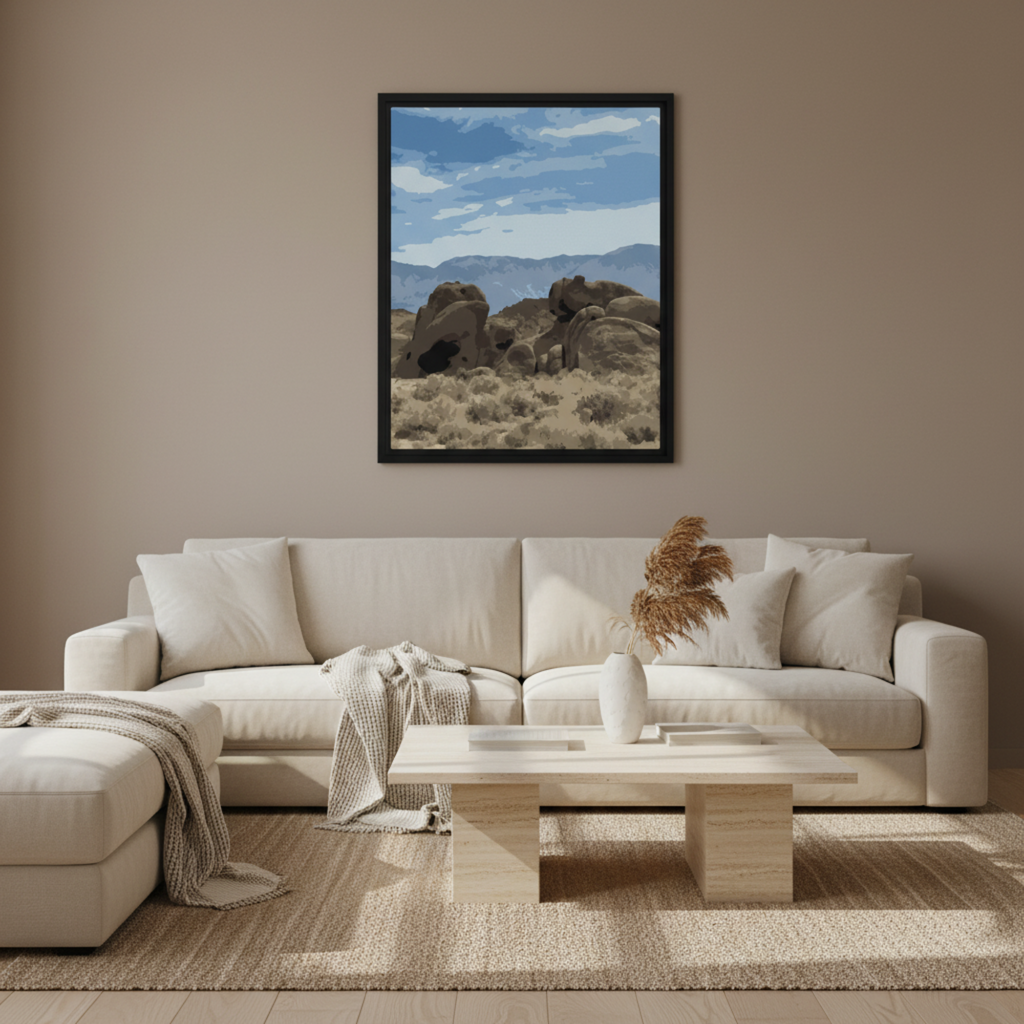 Living room with a beige sofa, coffee table, and alabama hills desert framed artwork.