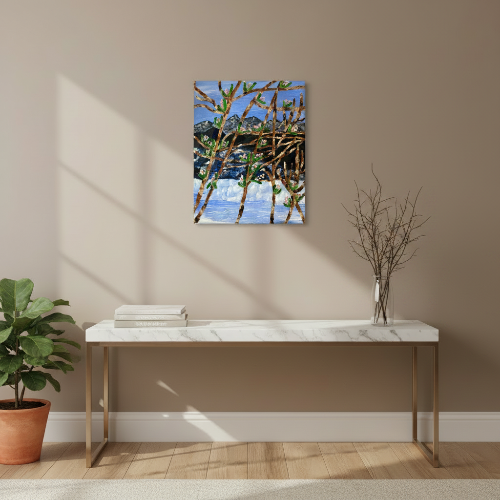 Modern interior with a marble console table, vase of branches, and 11x14 wall art od mountain environment.