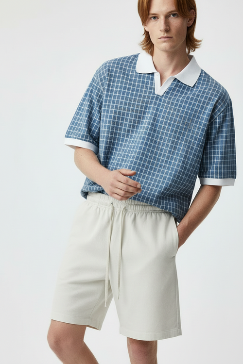 model wearing front view of boxy plaid polo