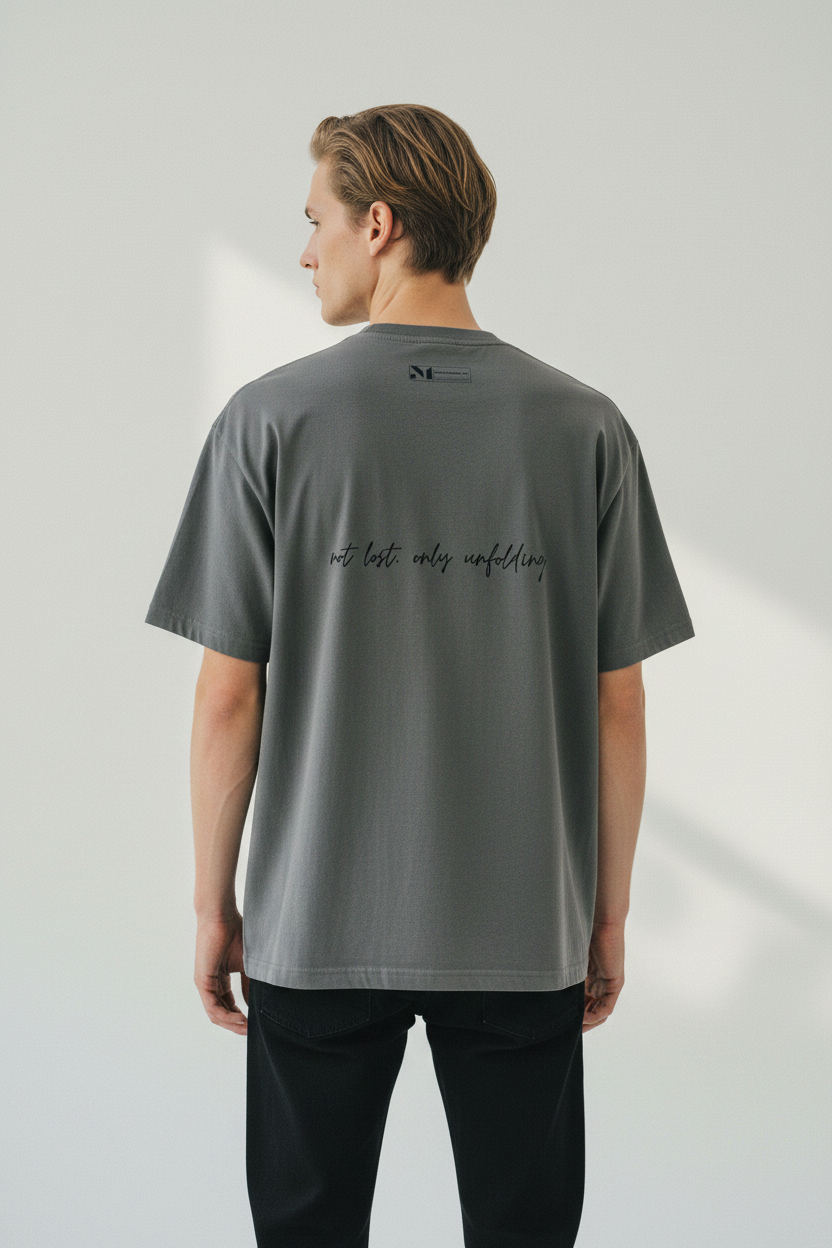back view of male model in heavyweight desert t-shirt with text 