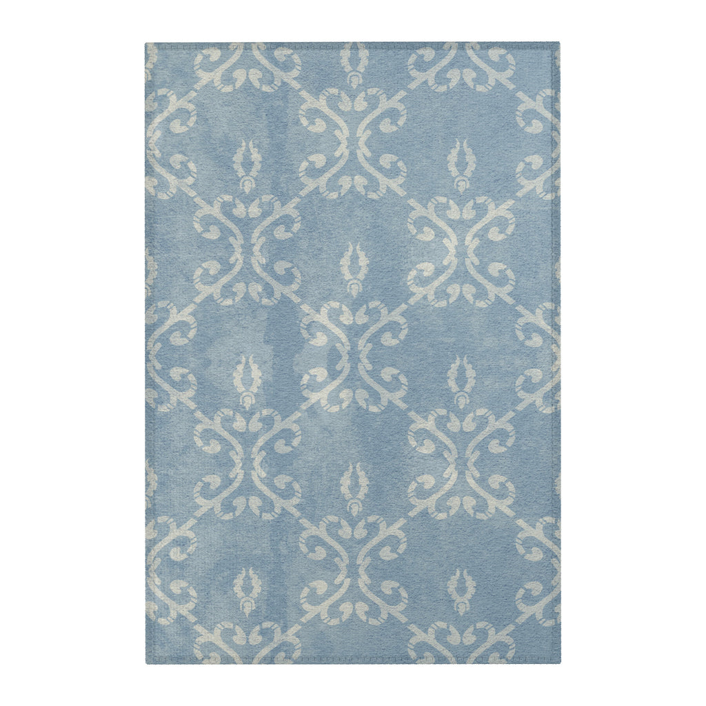flat lay of vintage distressed dusty blue damask area rug 