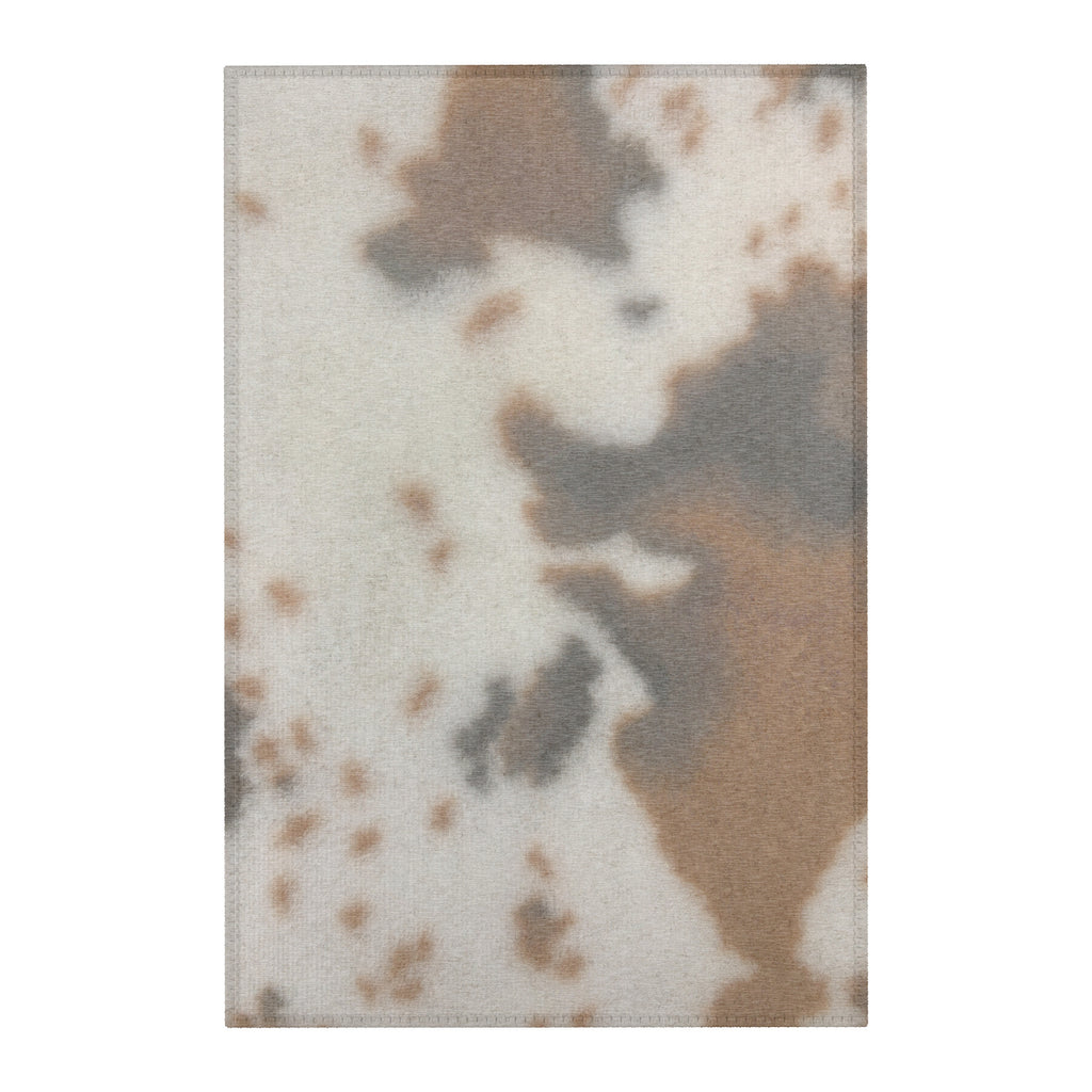 brown cow print rug with distressed worn texture 