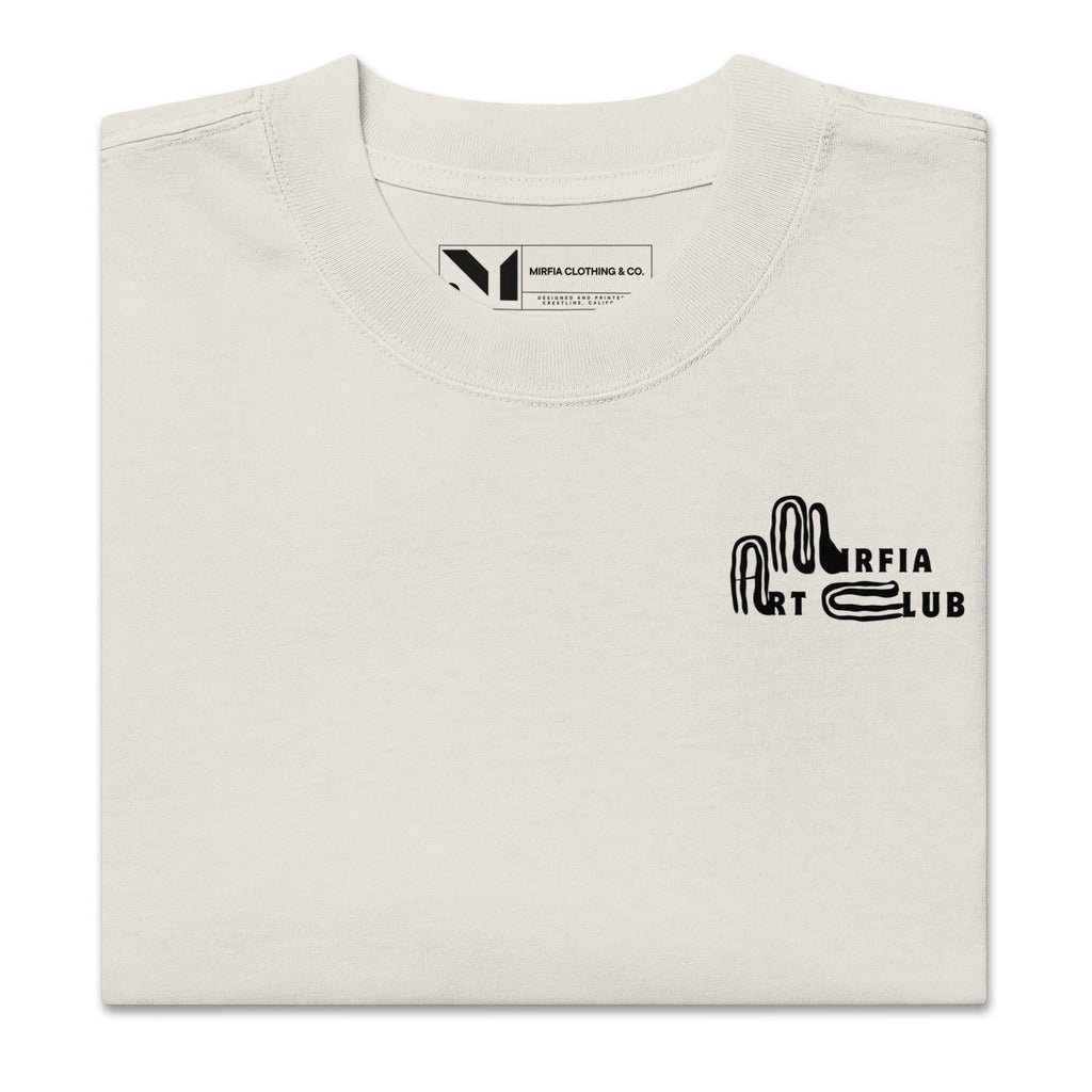 Folded beige oversized t-shirt with black text on a white background