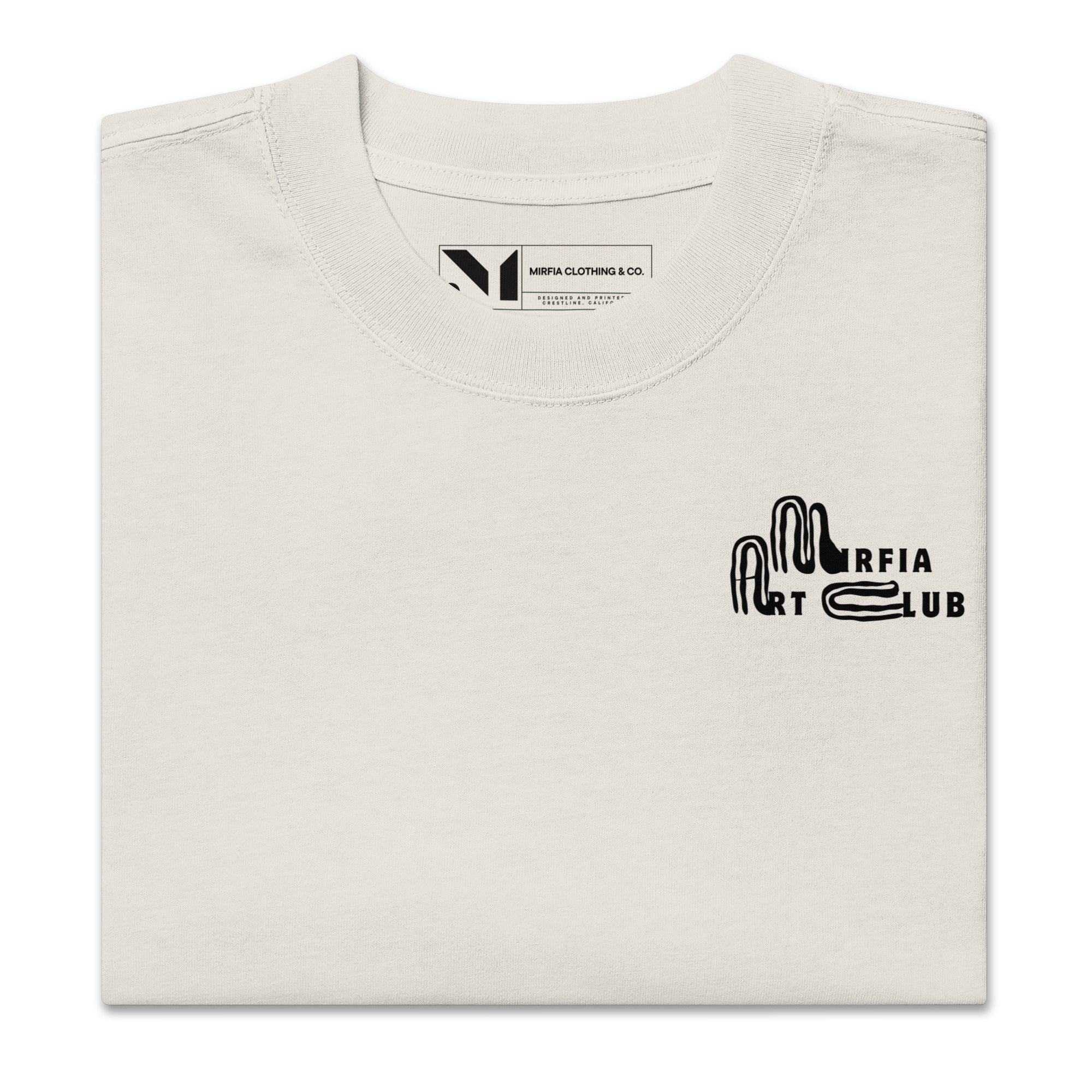 Folded beige oversized t-shirt with black text on a white background