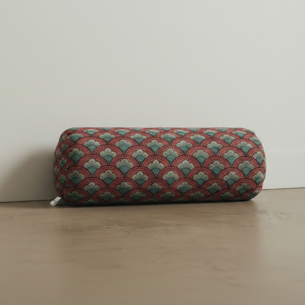 Decorative cylindrical faux suede bolster pillow with a geometric floral pattern