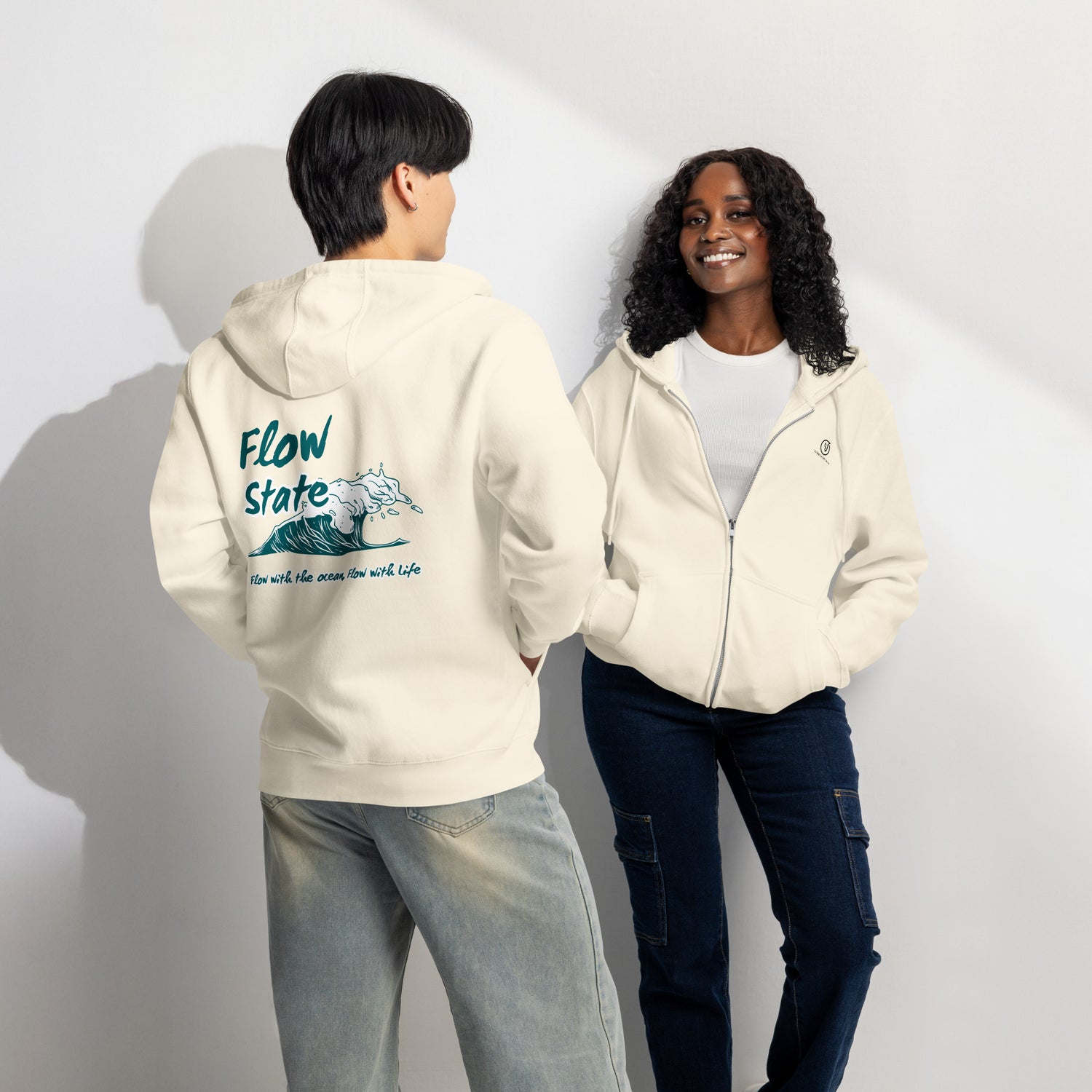 Two people wearing cream hoodies with a visible brand logo and back 'Flow State' graphic