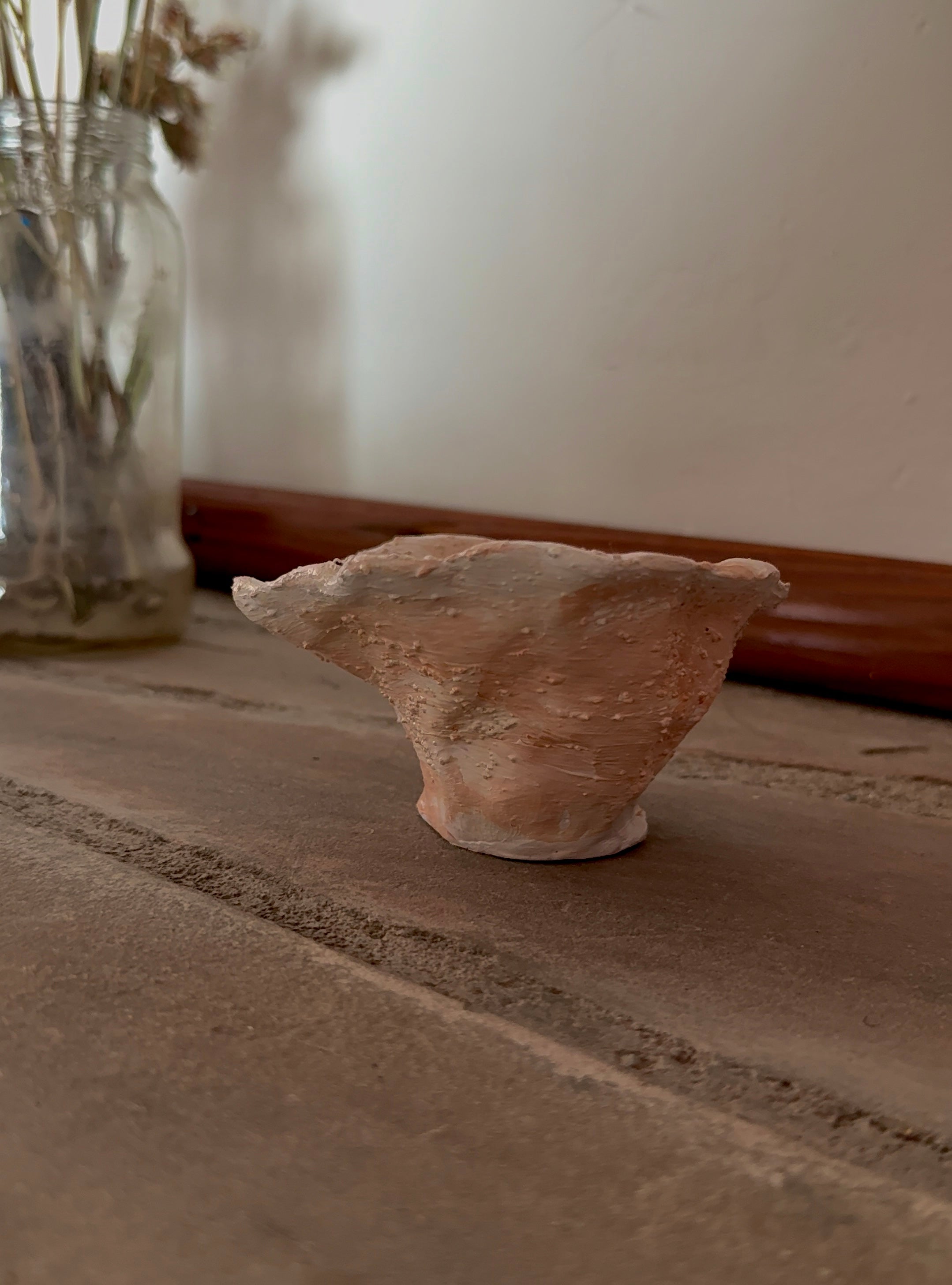A small handmade terracotta ceramic textured trinket bowl