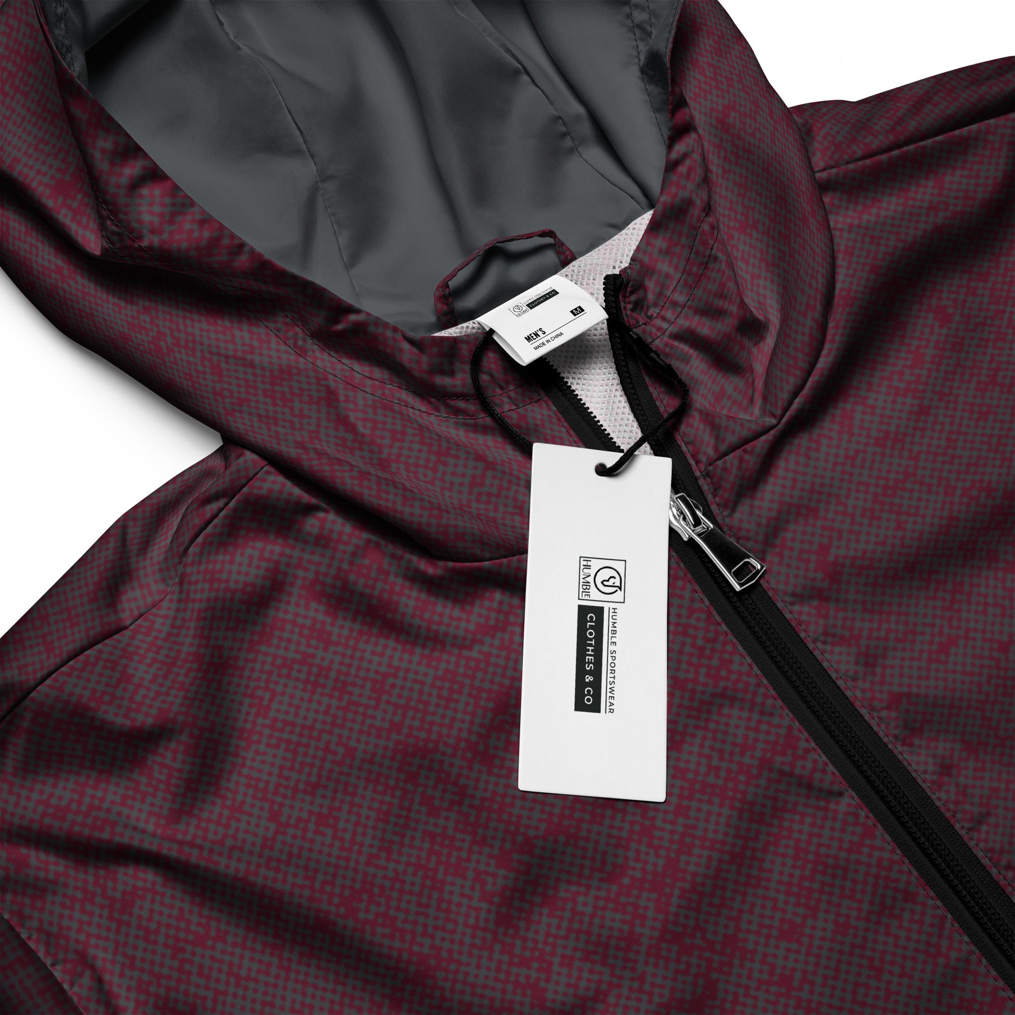 Maroon windbreaker jacket with a brand tag on a white background