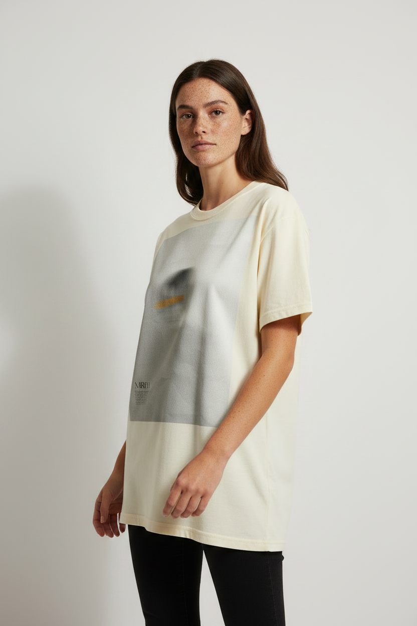 model wearing a cream t-shirt with a graphic design on a plain background