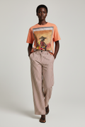 female model wearing a graphic t-shirt and striped pants