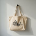 organic cotton art tote bag hanging on a hook