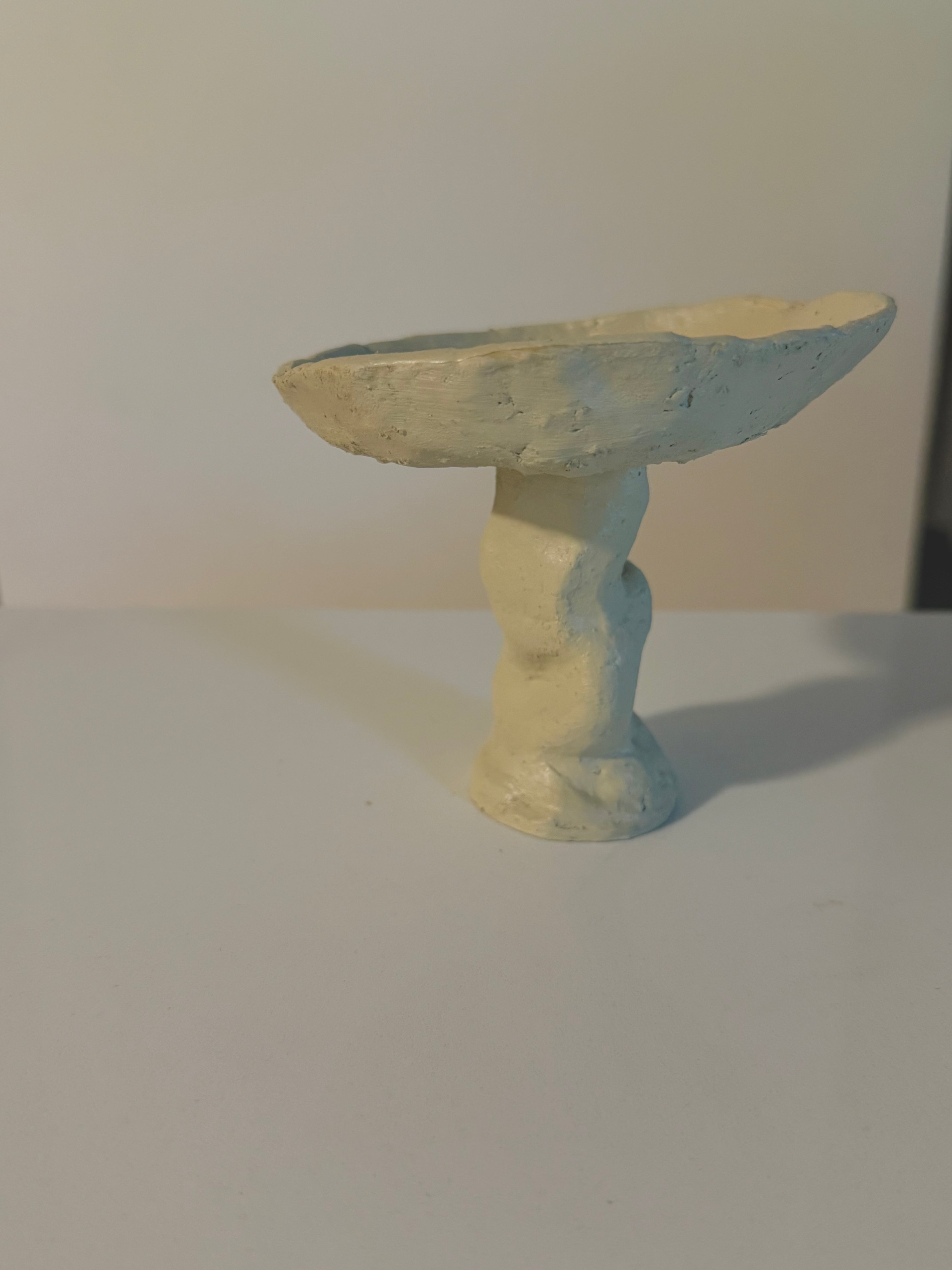 Artistic pedestal bowl with an irregular shallow bowl silhouette.