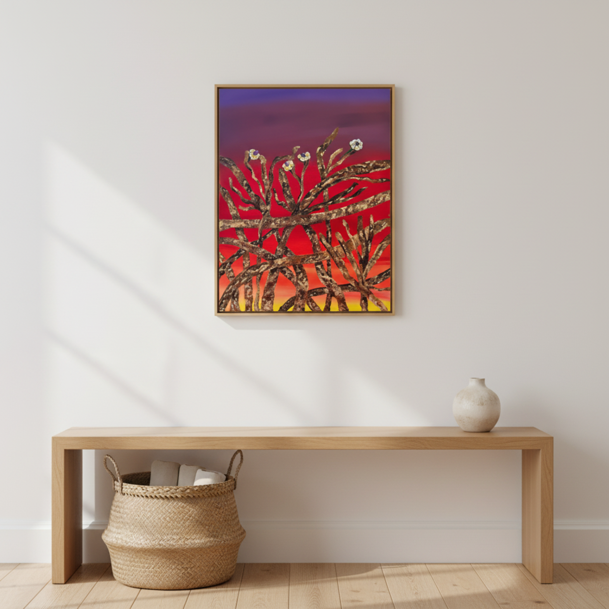Abstract painting on a wall above a wooden bench with a woven basket and vase.