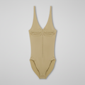 A beige one-piece ruched sporty bodysuit with a deep V-neckline and wide shoulder straps