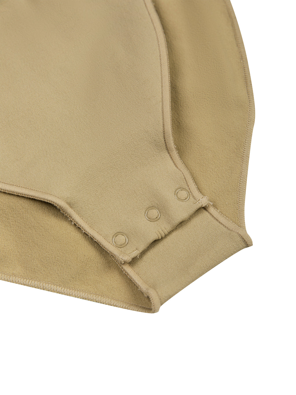 Close-up of a beige sporty bodysuit with button details 