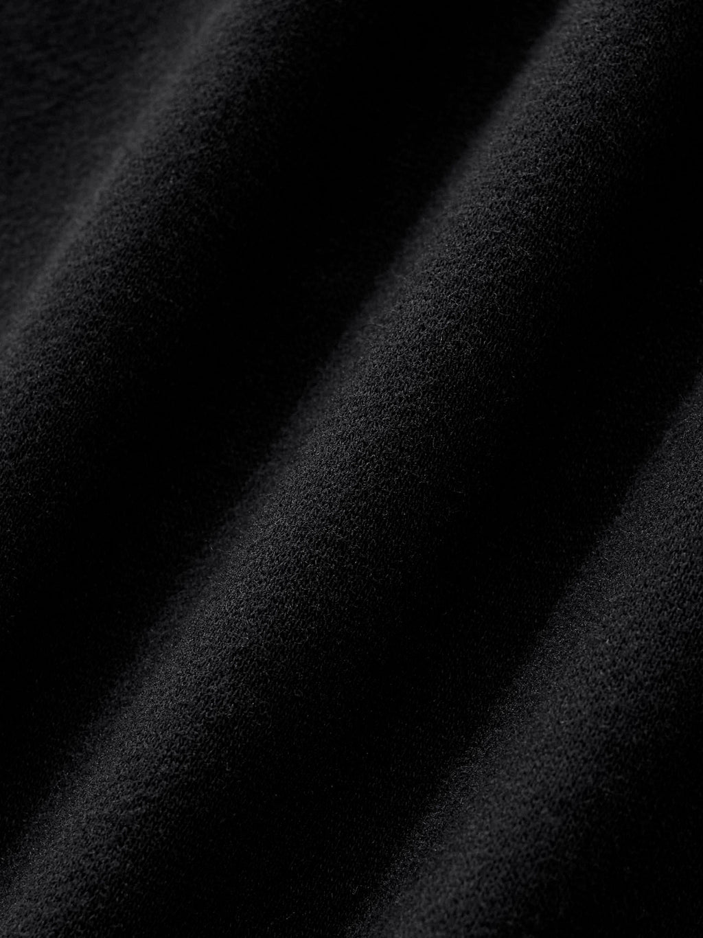 close up of fabric detail of black side stripe straight leg cargo pants