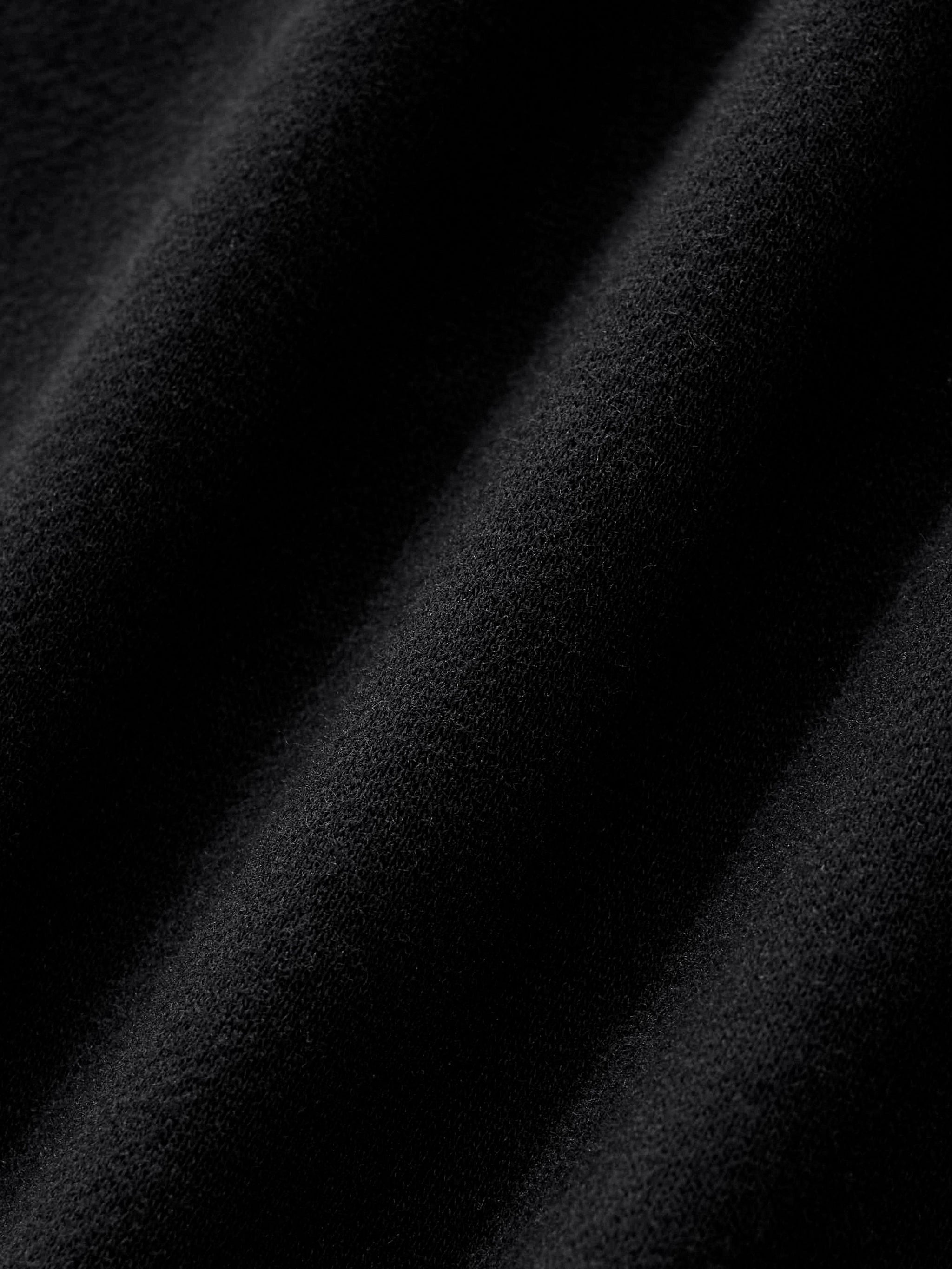 close up of fabric detail of black side stripe straight leg cargo pants