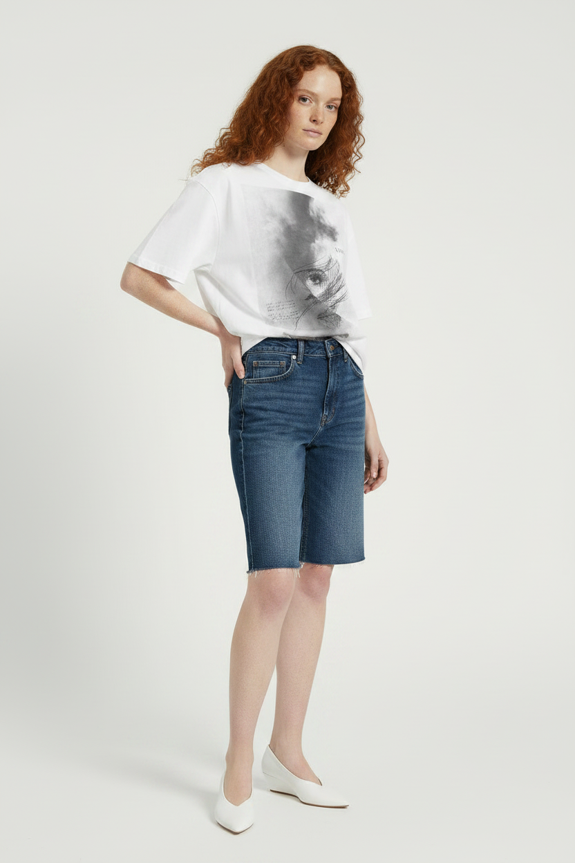 Woman wearing a white t-shirt and blue denim shorts on a white background