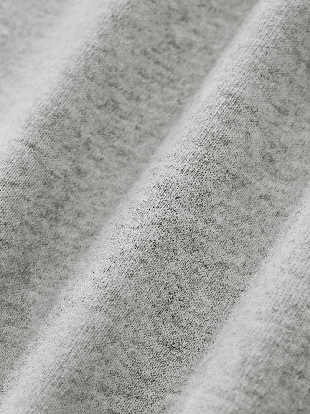 Close-up of gray fabric on gray quarter zip sweatshirt
