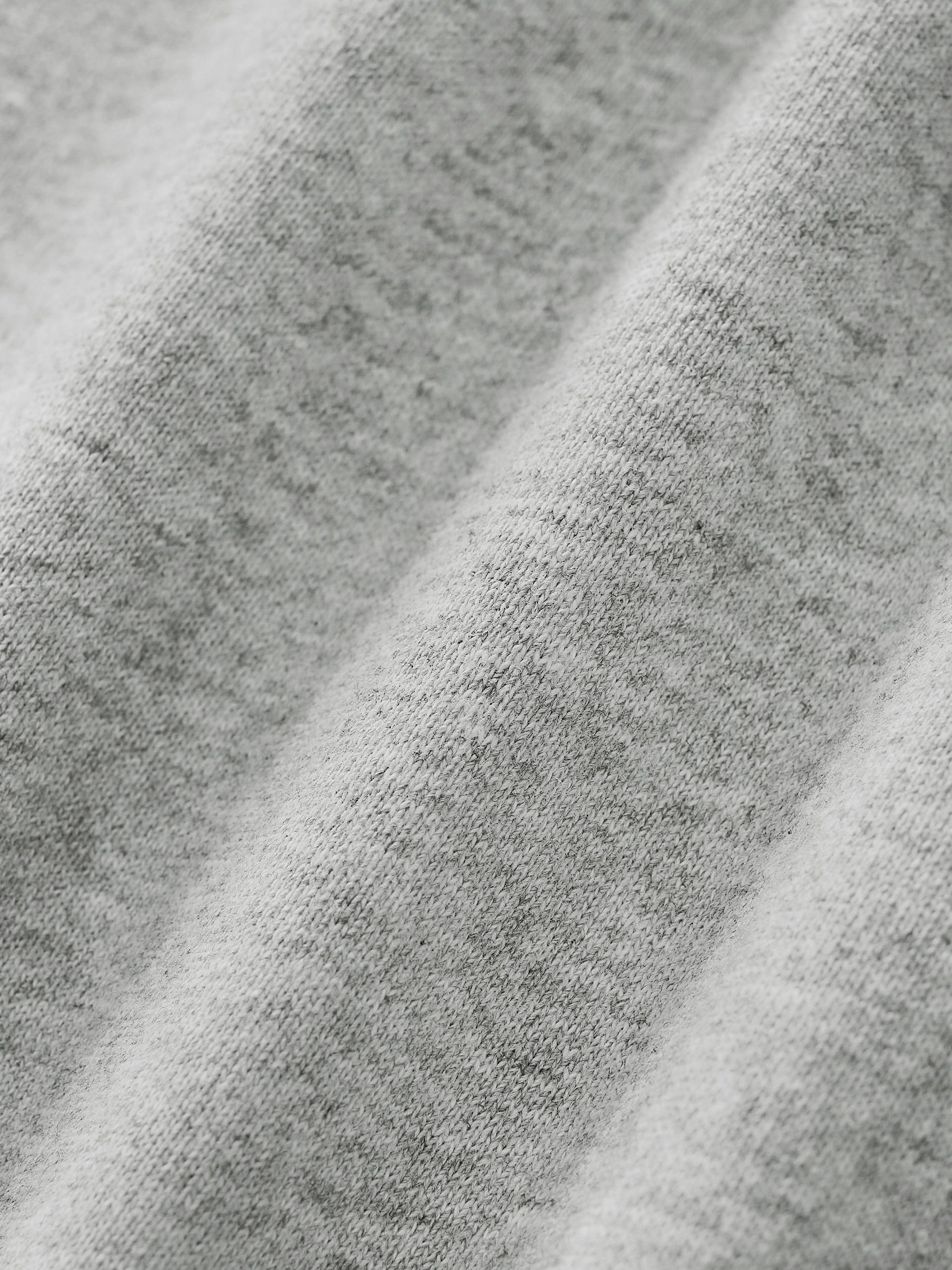 Close-up of gray fabric on gray quarter zip sweatshirt