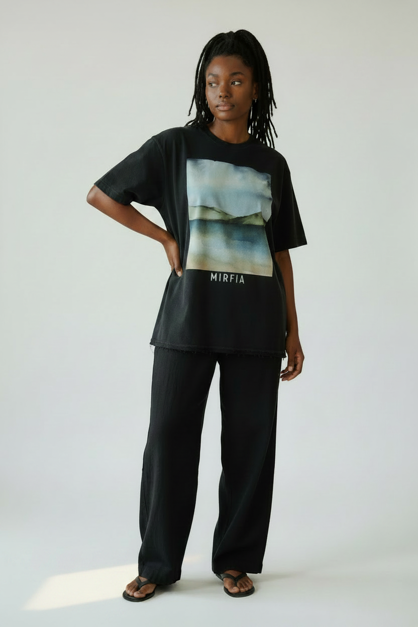model wearing muted ocean sky mountain graphic on vintage washed shirt 