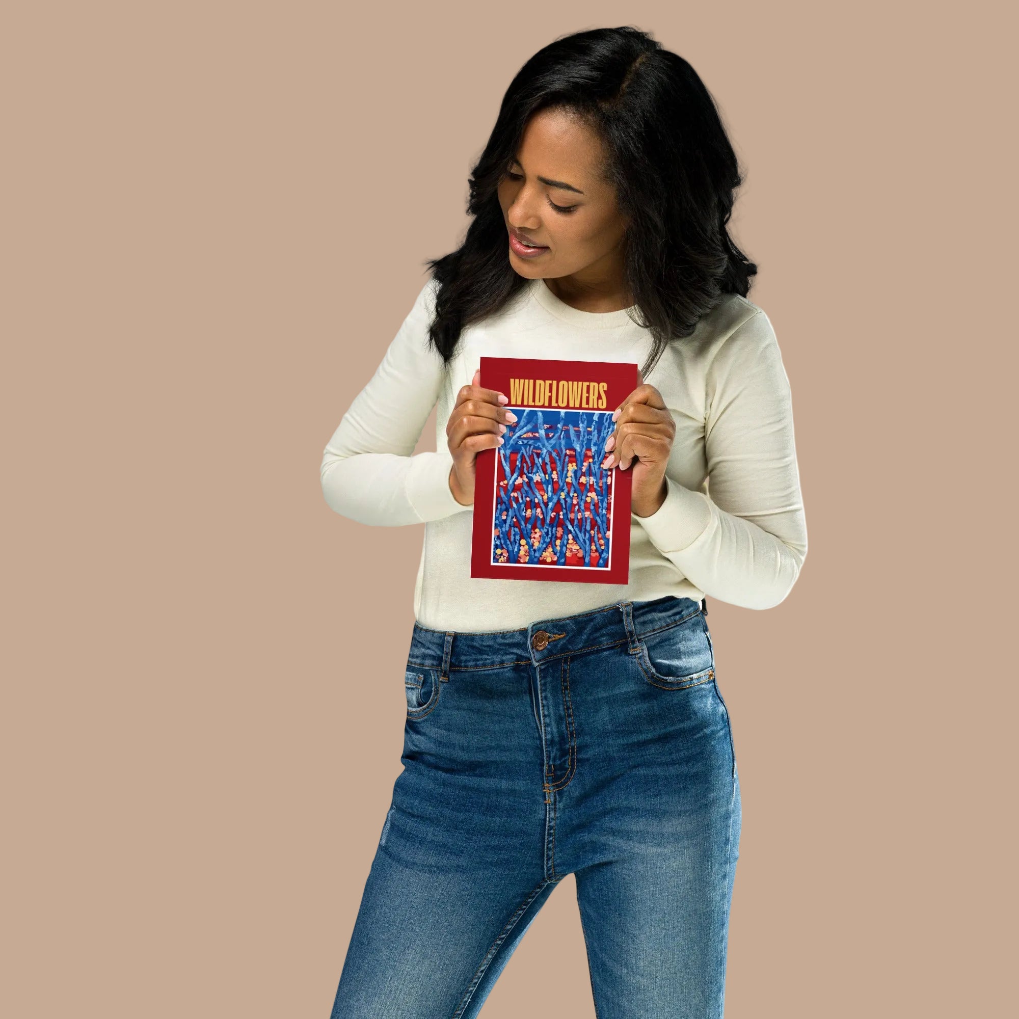 Woman holding a small contemporary floral wall art poster with bold blue and red tones 
