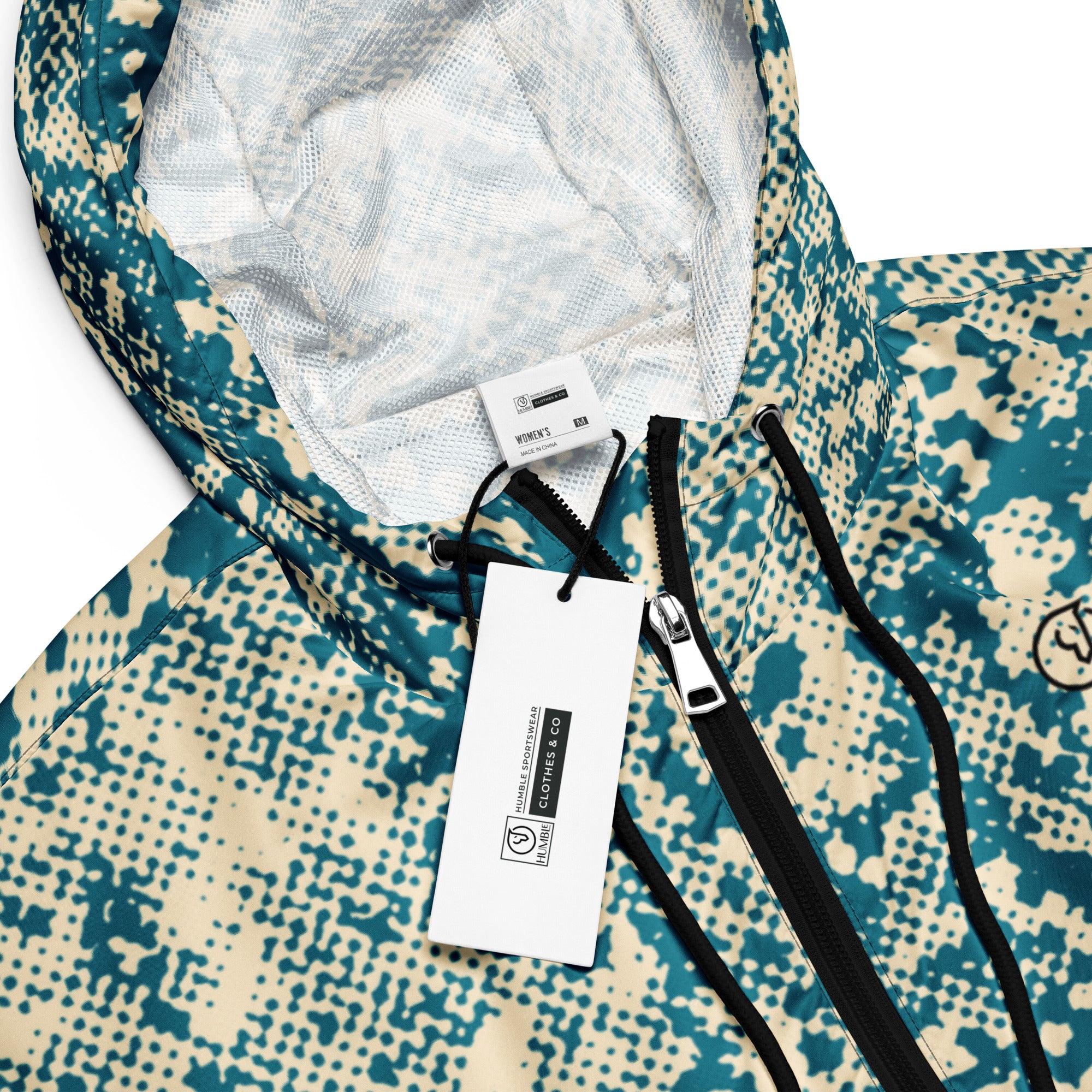 Close-up of a patterned windbreaker jacket with a brand tag and zipper details.