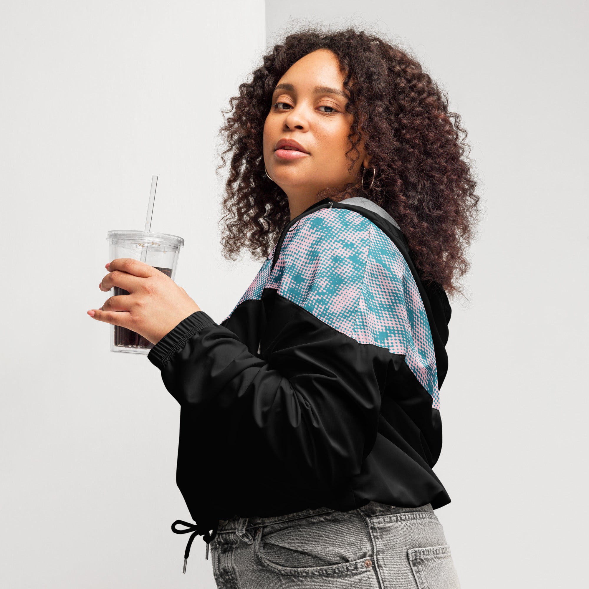 left side view of model wearing women's black multicolored cropped windbreaker hoodie 