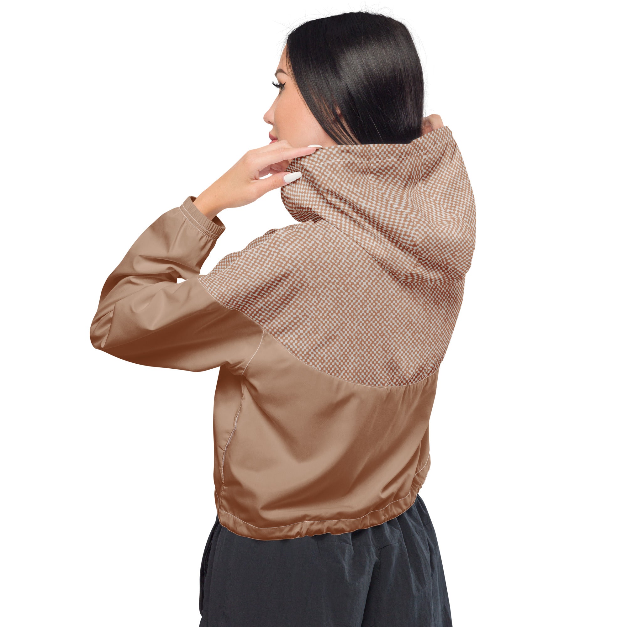 Person wearing a brown windbreaker jacket with a white background