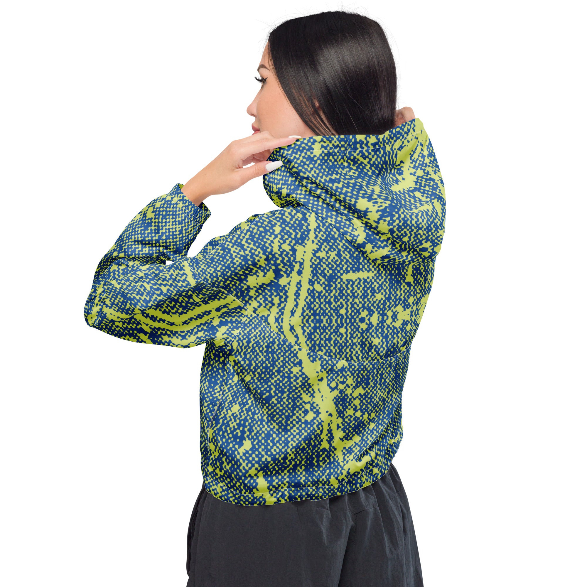 Person wearing a blue and green patterned windbreaker jacket with a hoodie