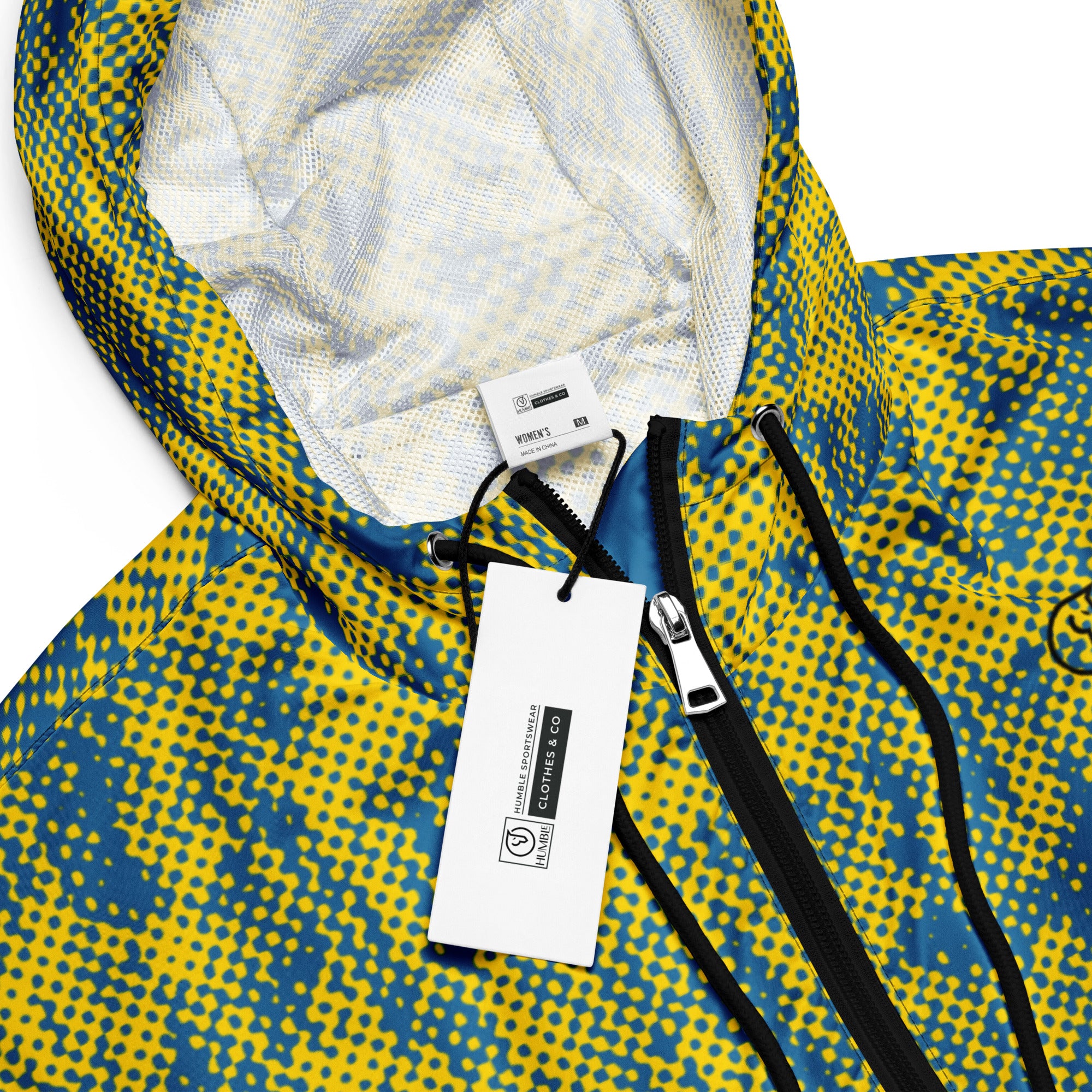 Close-up of a yellow and blue patterned windbreaker jacket with a brand tag on a white background