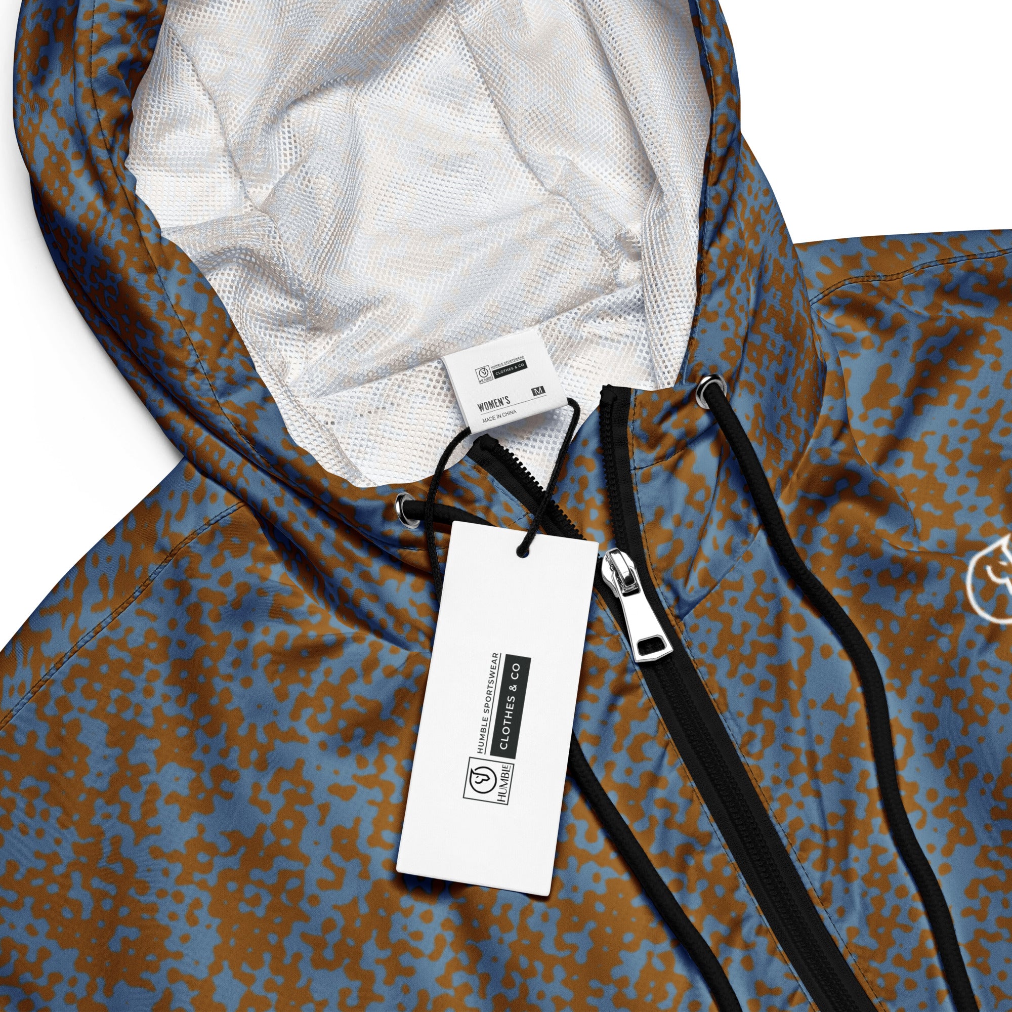 Close-up of a patterned windbreaker jacket with a brand tag, on a white background