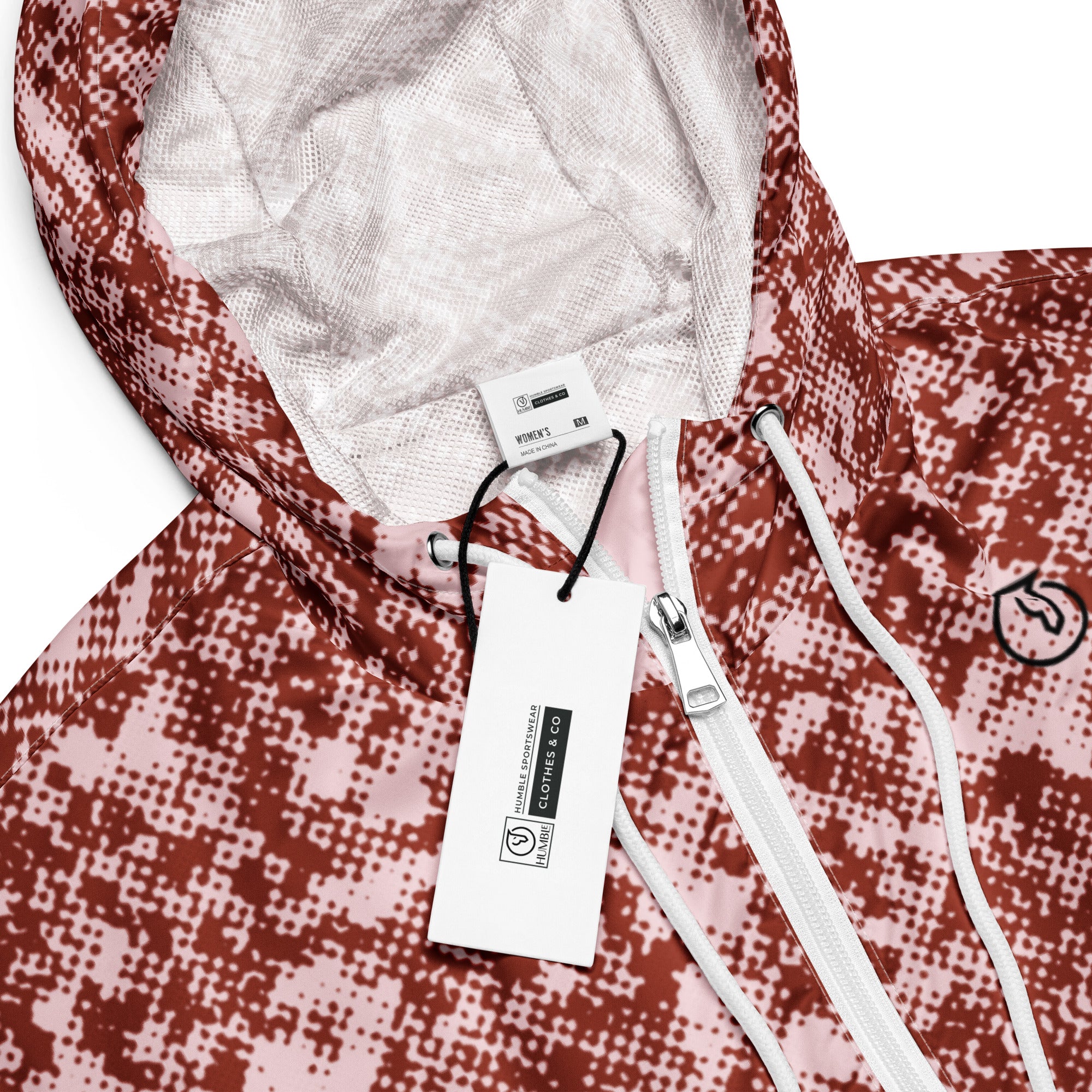 Close-up of a red and white patterned windbreaker jacket with a brand tag and drawstring.