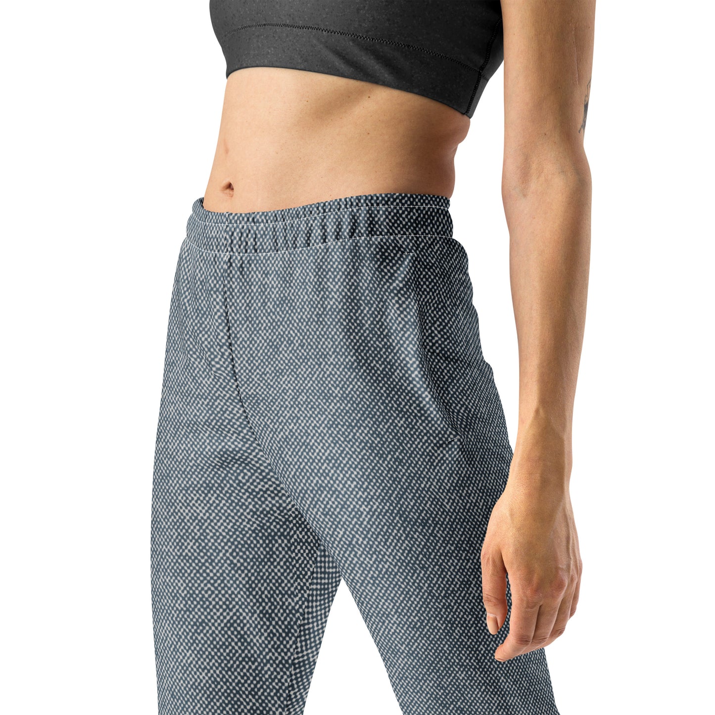 Person wearing blue patterned slim fit jogger pants on a white background