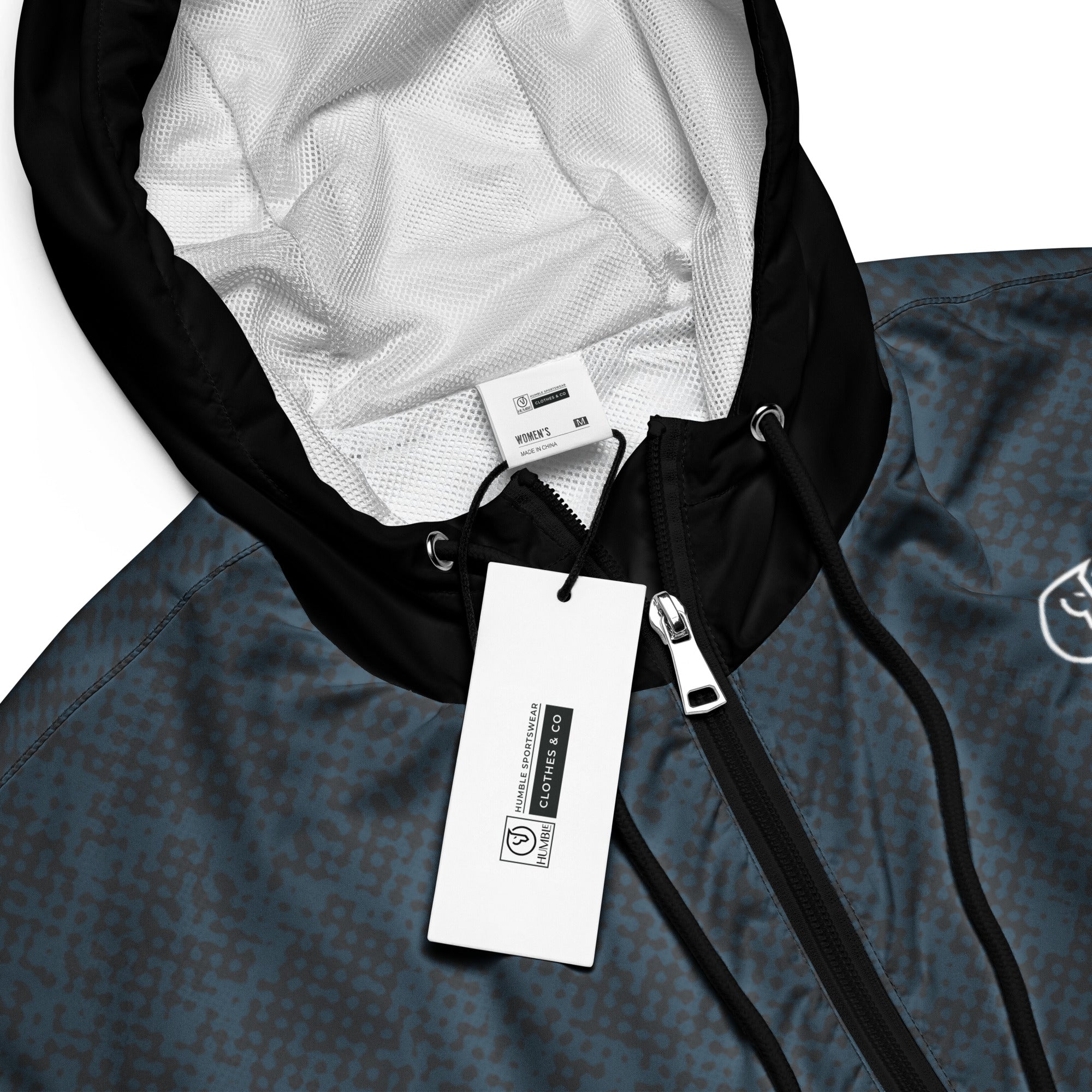 Close-up of a windbreaker jacket hoodie with a tag on a white background