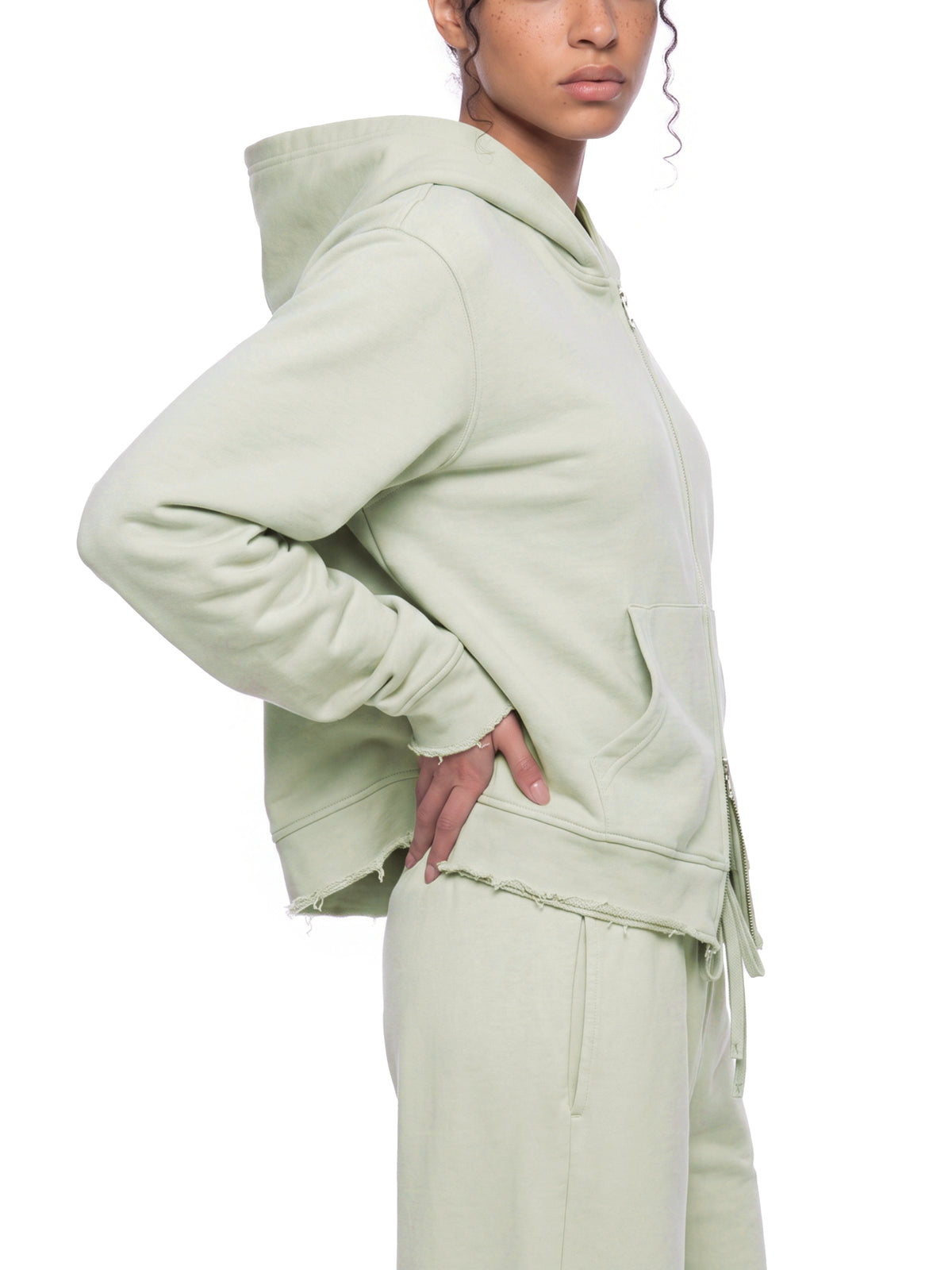 side view of relaxed fit raw edge zip hoodie 