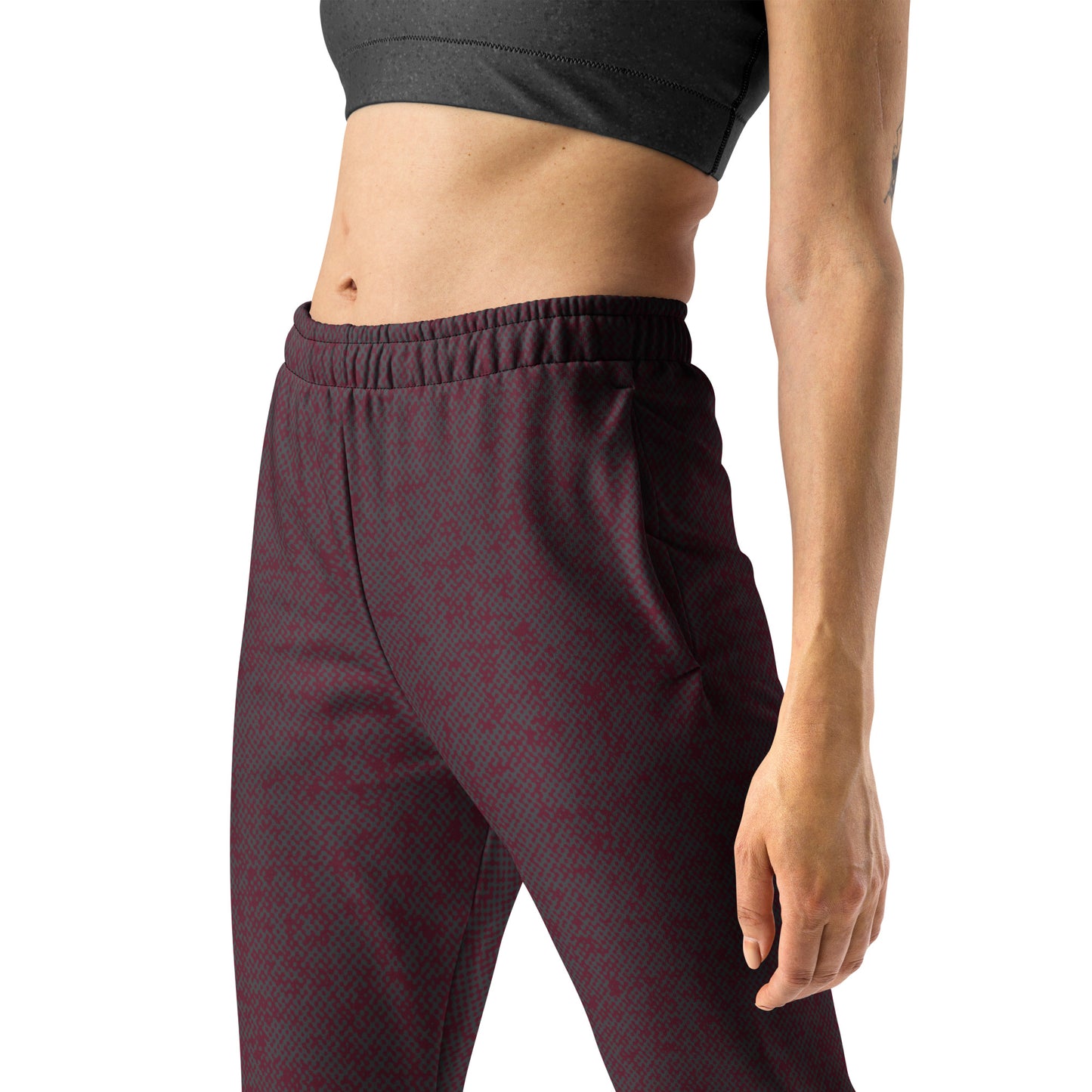 Maroon patterned slim fit jogger pants worn by a woman on a white background