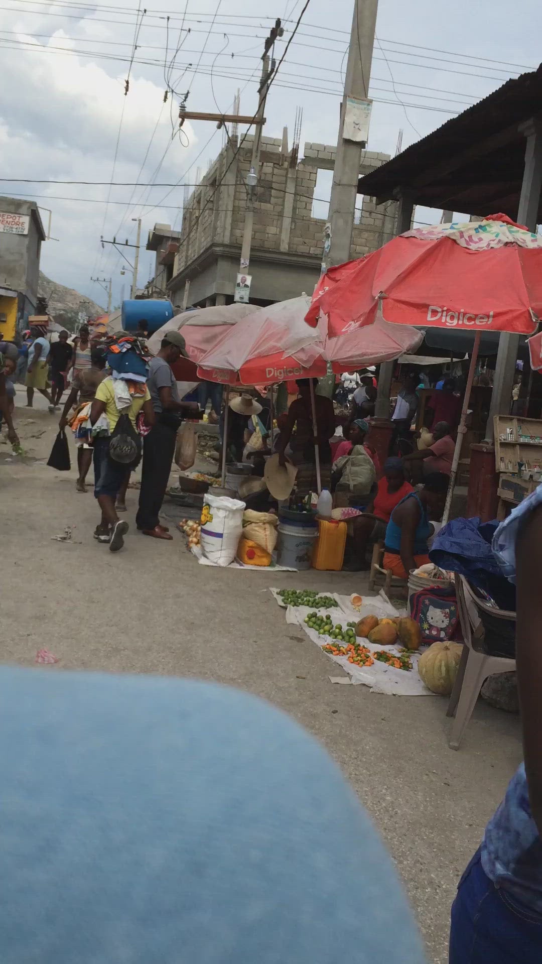 Busy Haitian market in Haiti, people selling and walking by